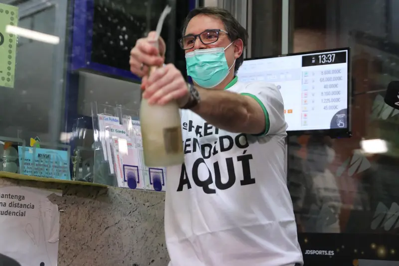 <p> Javier Mo&ntilde;ino, empleado de la administraci&oacute;n situada en la zona del AVE de la Estaci&oacute;n de Atocha, abre una botella para celebrar que ha vendido parte del n&uacute;mero 86148 correspondiente al 'Gordo' del Sorteo Extraordinario de la Loter&iacute;a de Navidad, a 22 de - Isabel Infantes - Europa Press </p>