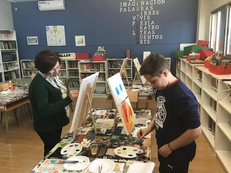 <p> Profesora con alumno en clase de arte. Twitter </p>