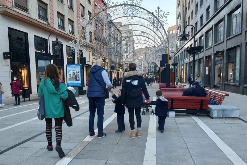<p> Una familia con ni&ntilde;os pasea por las calles de Oviedo durante la Navidad de 2021. - EUROPA PRESS </p>