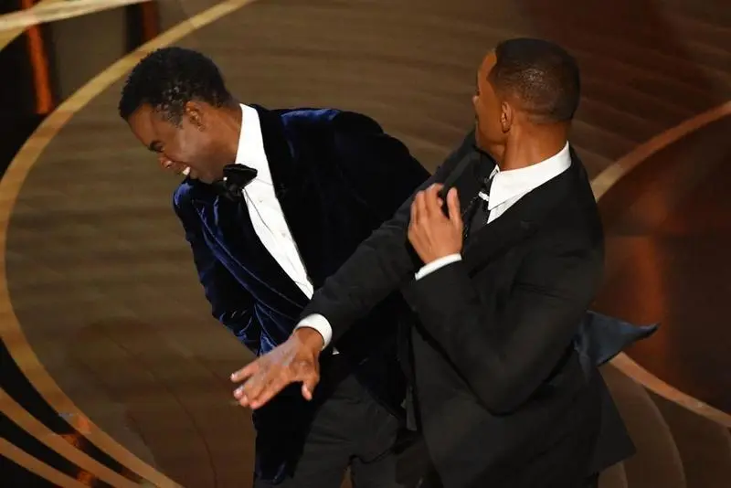 US actor Will Smith (R) slaps US actor Chris Rock speaks onstage during the 94th Oscars at the Dolby Theatre in Hollywood, California on March 27, 2022. (Photo by Robyn Beck / AFP)