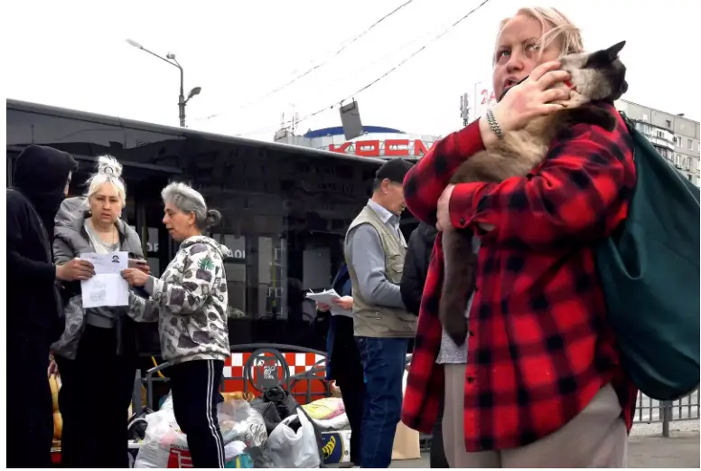 <p> Refugiados ucranianos abandonando la estaci&oacute;n en la que estaban viviendo </p>