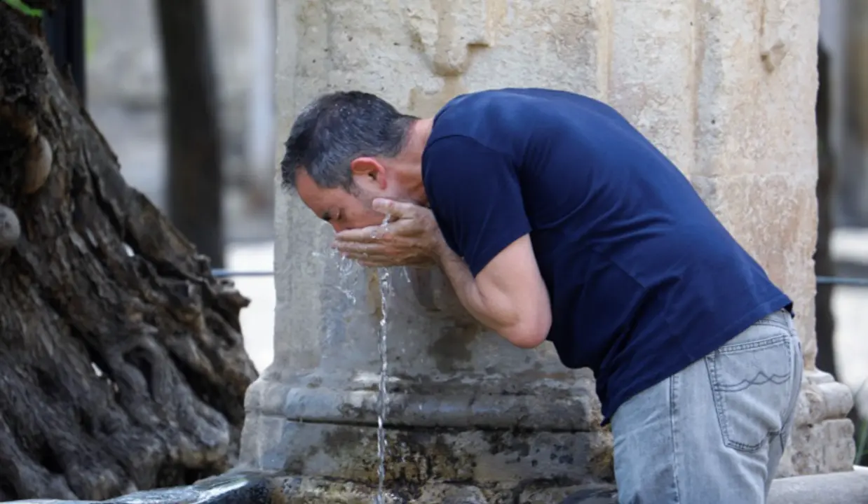  Un hombre se refresca en una fuente (C&oacute;rdoba). 