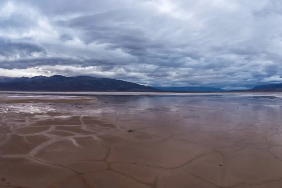  El barro agrietado y la sal en el fondo del valle del Parque Nacional del Valle de la Muerte en California pueden convertirse en un estanque reflectante despu&eacute;s de las lluvias - NPS/KURT MOSES | EP 