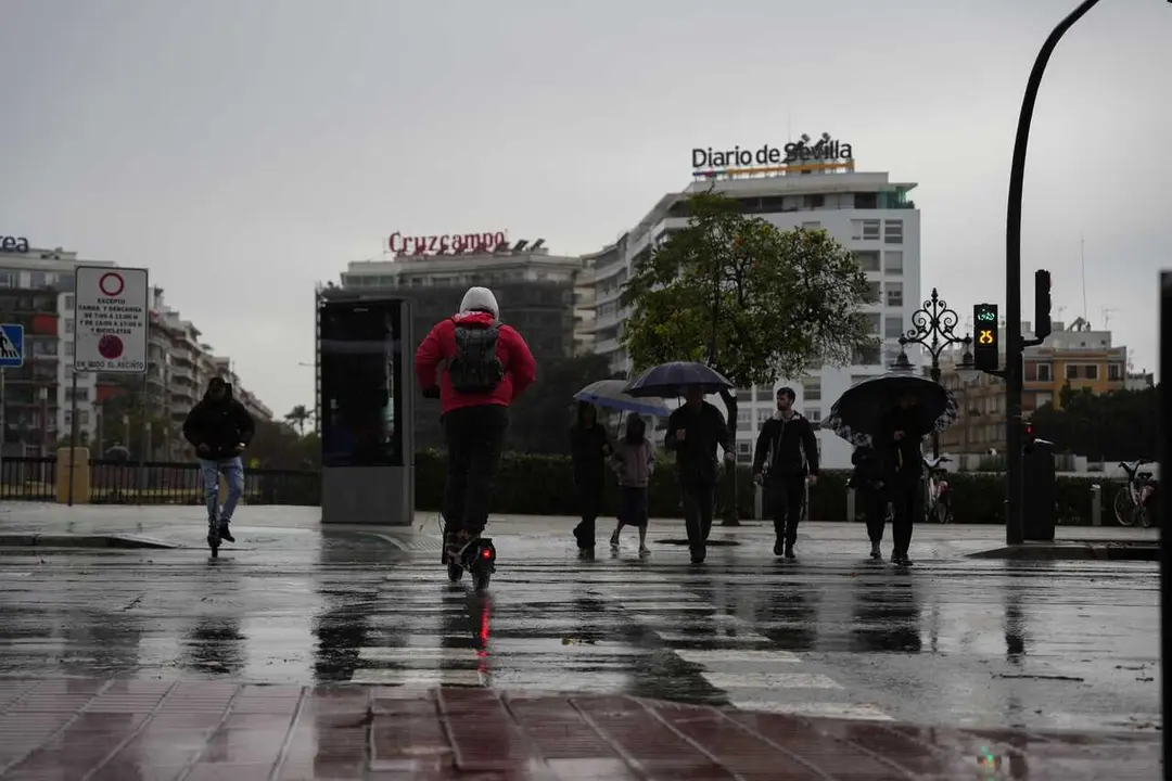 Peatones se protegen de la lluvia bajo sus paraguas, durante el paso de la borrasca Joseph. A 27 de enero del 2026 en Sevilla (Andaluc&iacute;a, Espa&ntilde;a). 