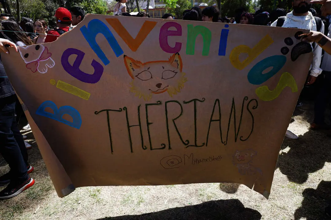 Students hold a placard to welcome Therians to Las Islas at the National Autonomous University of Mexico (UNAM), expressing their feeling of being like animals and ''experiencing a deep, psychological, or spiritual connection with an animal.'' According to the Therian subculture, their activities may include group dynamics, quadrobics (movement on all fours), the use of animal masks and accessories, and spaces for sharing experiences related to this identity.