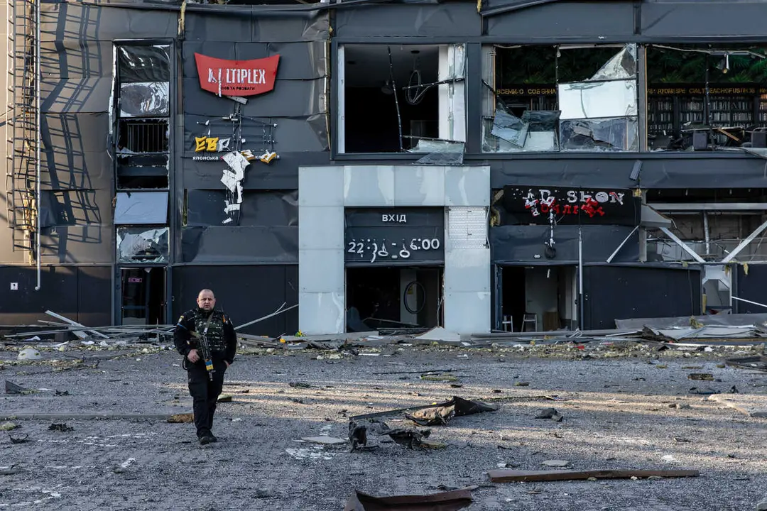 Ukrainian soldier seen patrolling with his rifle at a bomb site during military curfew. Amid Russia's offensive on the capital city of Ukraine, the Retroville mall in Podilskyi district, Kiyv, Ukraine was bombed by a Russian missile on Monday night around 22:30, March 21, 2022, in Kyiv, Ukraine, killing at least 8 people.