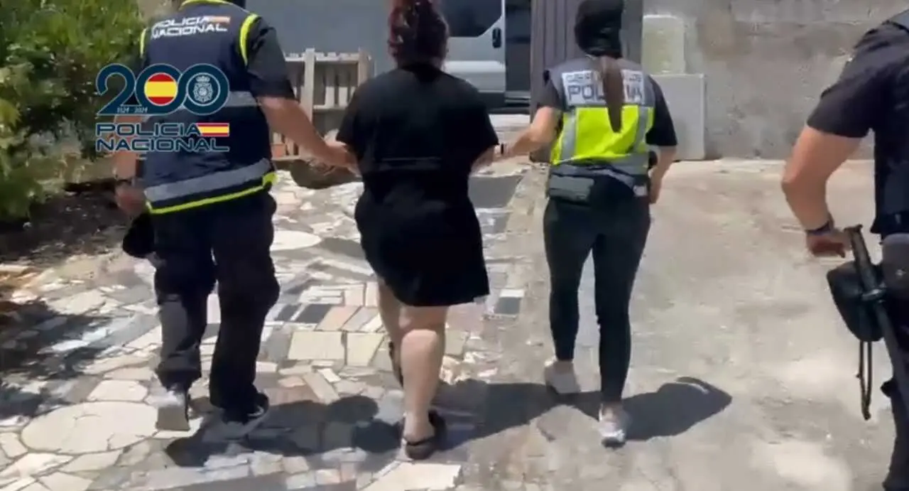 Agentes de la Polic&iacute;a con una de las detenidas de la organizaci&oacute;n que explotada sexualmente a mujeres de origen chino.