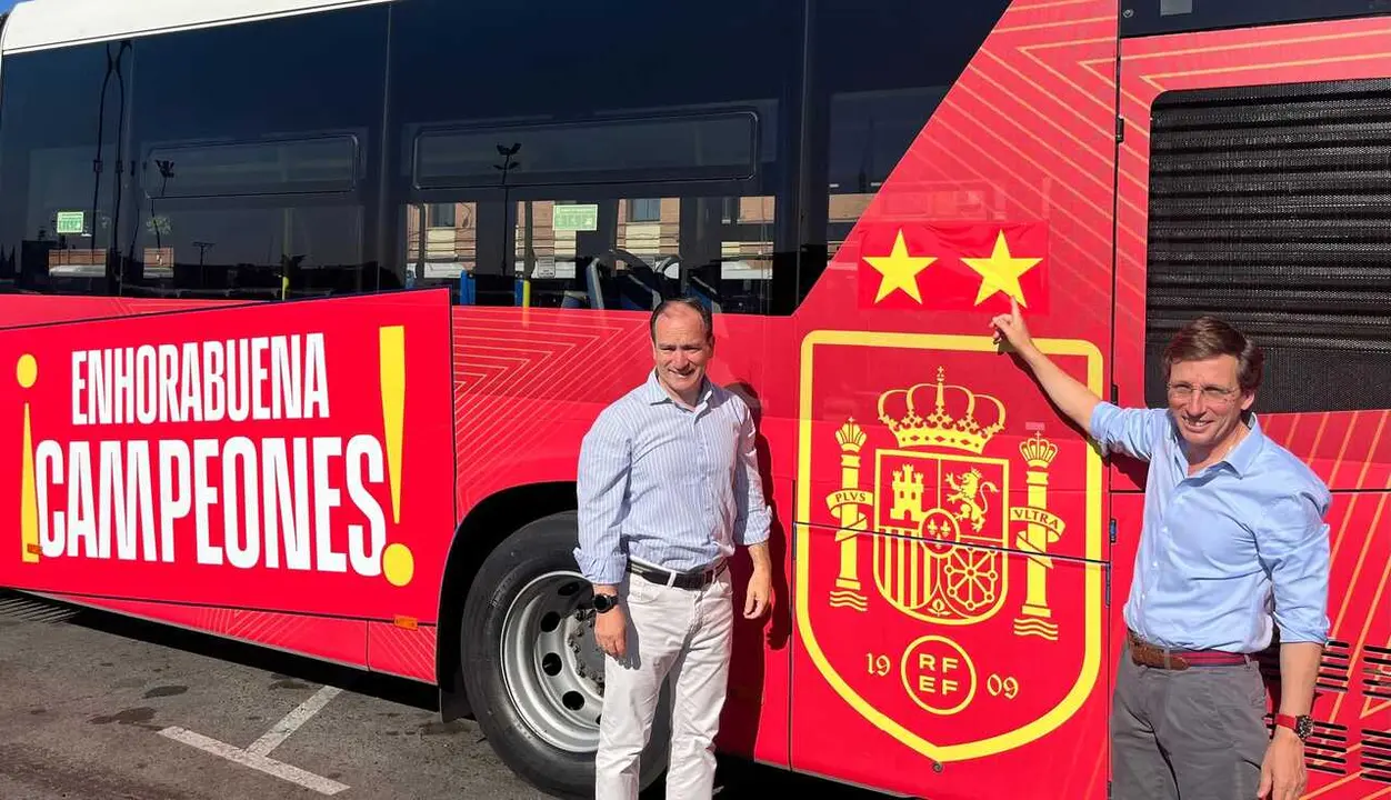 El alcalde de Madrid, Jos&eacute; Luis Mart&iacute;nez-Almeida (i), y el delegado de Urbanismo, Movilidad y Medio Ambiente, Borja Carabante (d), colocan la segunda estrella en un bus de la EMT vinilado en apoyo a la Selecci&oacute;n.