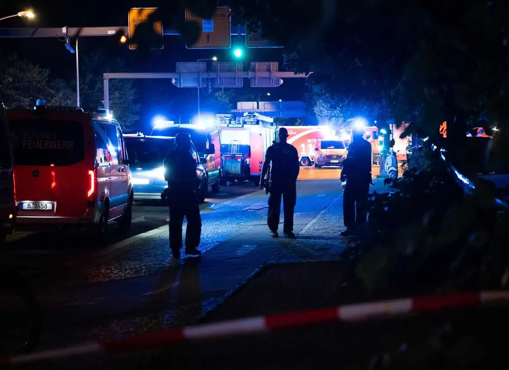 BERLIN, July 26, 2026  -- Police officers work near the site where a car drove into a crowd in Berlin, Germany, July 26, 2026. One person was killed and 16 others were injured, including several with life-threatening injuries, after a car drove into a cro