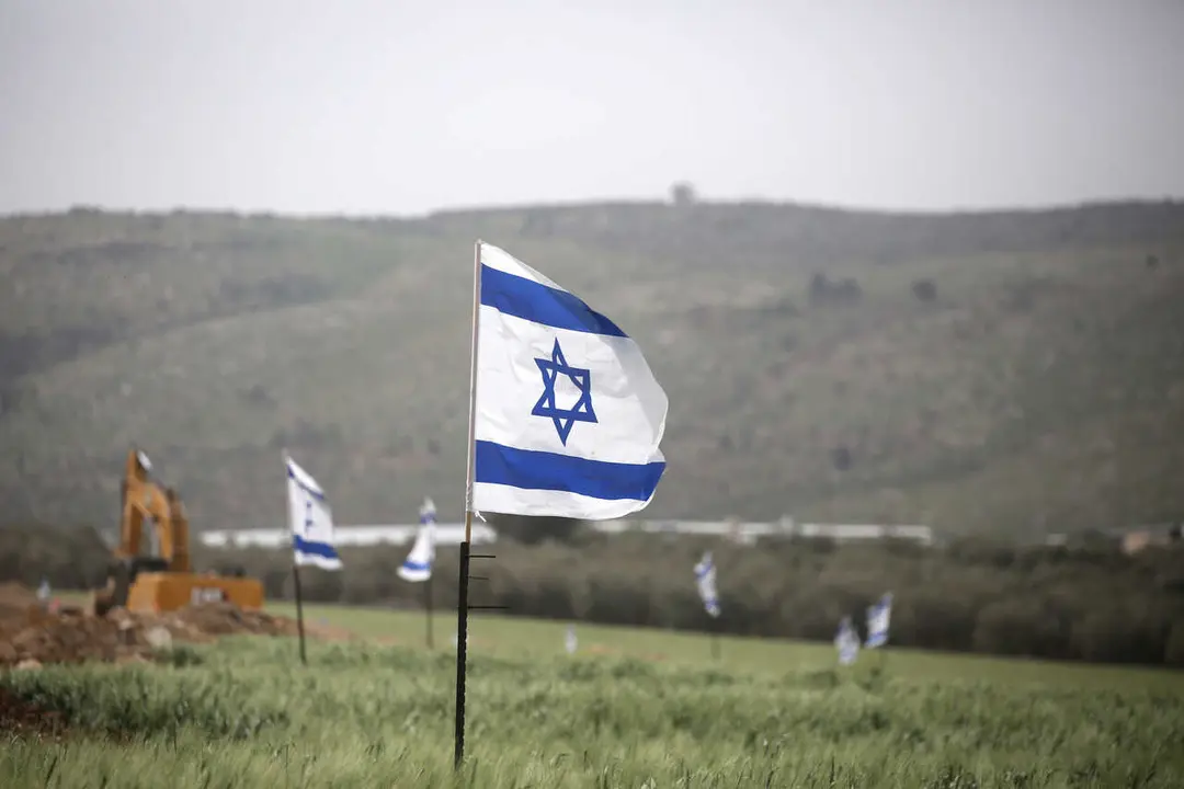 An Israeli bulldozer seen razing Palestinian-owned land near the Jewish settlement of Snanur. Jewish settlers have returned to their abandoned settlement and raised Israeli flags around the Snanur settlement, south of Jenin in the West Bank. Snanur was one of four settlements in the northern West Bank evacuated in 2005 as part of the ''disengagement'' plan.