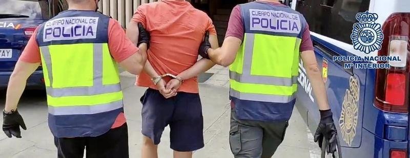 <p> Dos agentes de la Policía Nacional acompañan a un detenido (detención, arresto) </p>