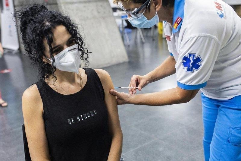  Un sanitario administra una dosis de la vacuna de Pfizer a una mujer en el Wizink Center durante la primera noche en la que el recinto está abierto a la vacunación, a 1 de julio de 2021, en Madrid (España). - Alejandro Martínez Vélez - Europa Press 