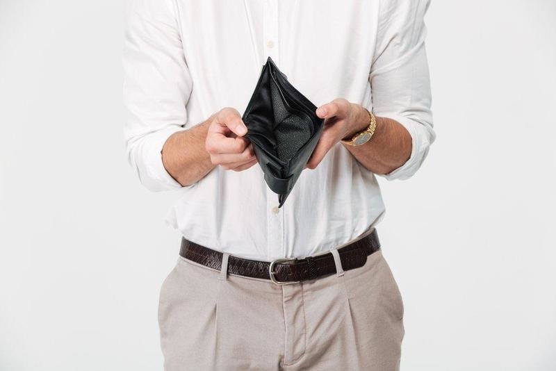 Close up portrait of a man showing empty wallet isolated over white background