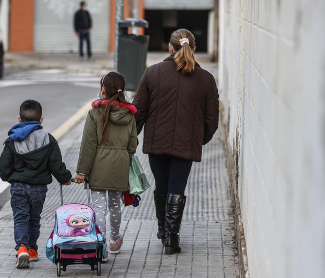 <p> Un niño y una niña, acompañados de una mujer, caminan hacia el colegio en Valencia. - Rober Solsona - Europa Press </p>