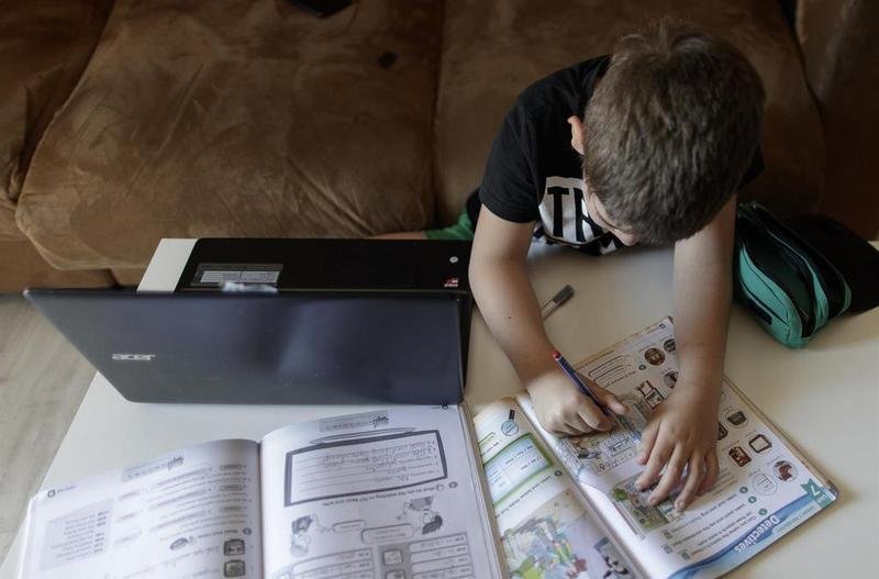 <p> Un alumno de Primaria haciendo deberes en su casa, en Madrid </p>