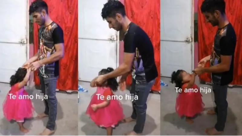  El padre bailando con su hija pequeña 