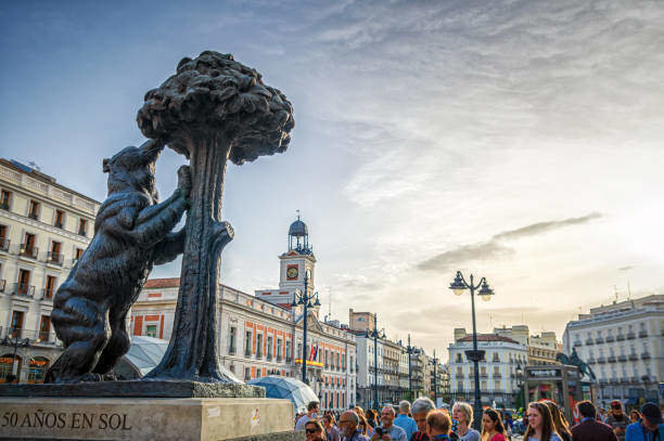 Madrid, Spain - April 24, 2018: tourists in front of the statue of bear and strawberry tree in Madrid, Spain. The bear is a symbol of Madrid and it is situated on Puerta del Sol square and was created by Antonio Navarro Santaf? in 1967