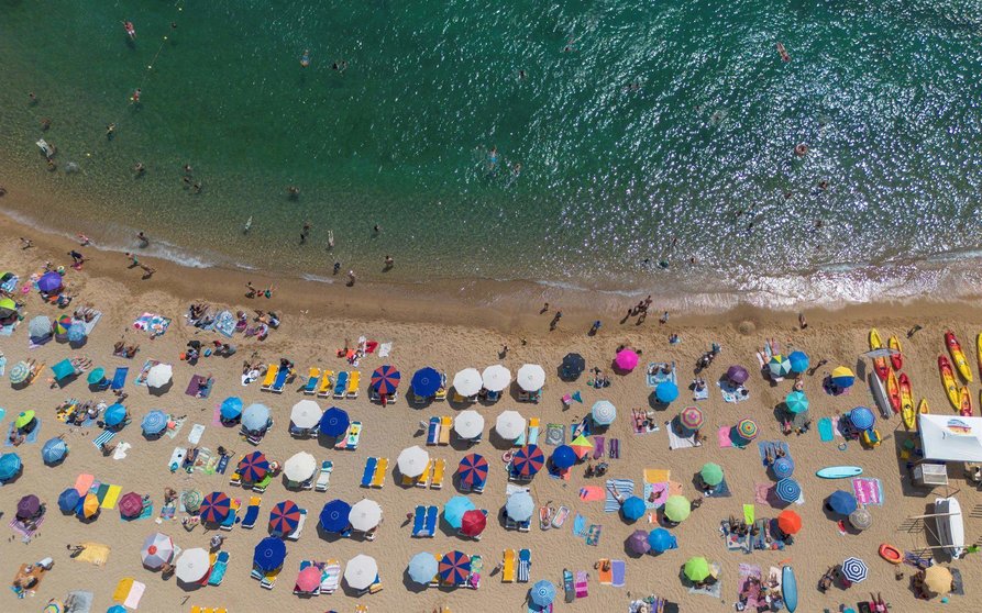  Numerosas personas disfrutan de un día de playa en la Costa Brava, en Tossa de Mar, Girona, Cataluña 