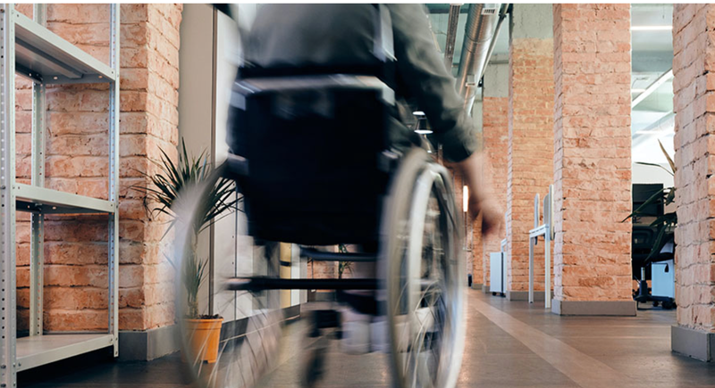  Una persona con discapacidad accede a un edificio 