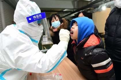  Personal médico realiza una prueba de coronavirus a un niño en Shijiazhuang, capital de Hebei, noreste de China. - -/TPG via ZUMA Press/dpa 
