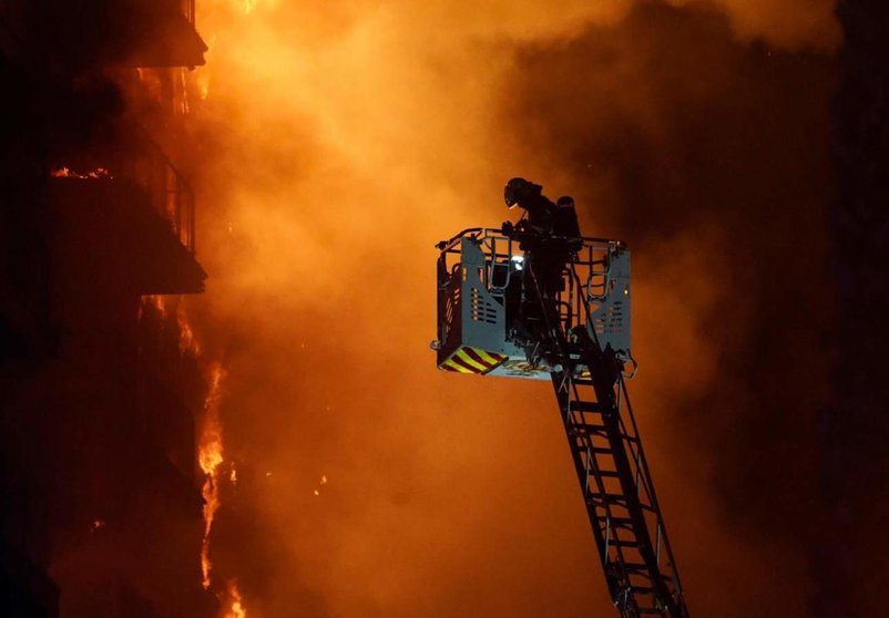  Un bombero trata de apagar el edificio en llamas, en el barrio de Campanar, a 22 de febrero de 2024 - Eduardo Manzana - Europa Press 