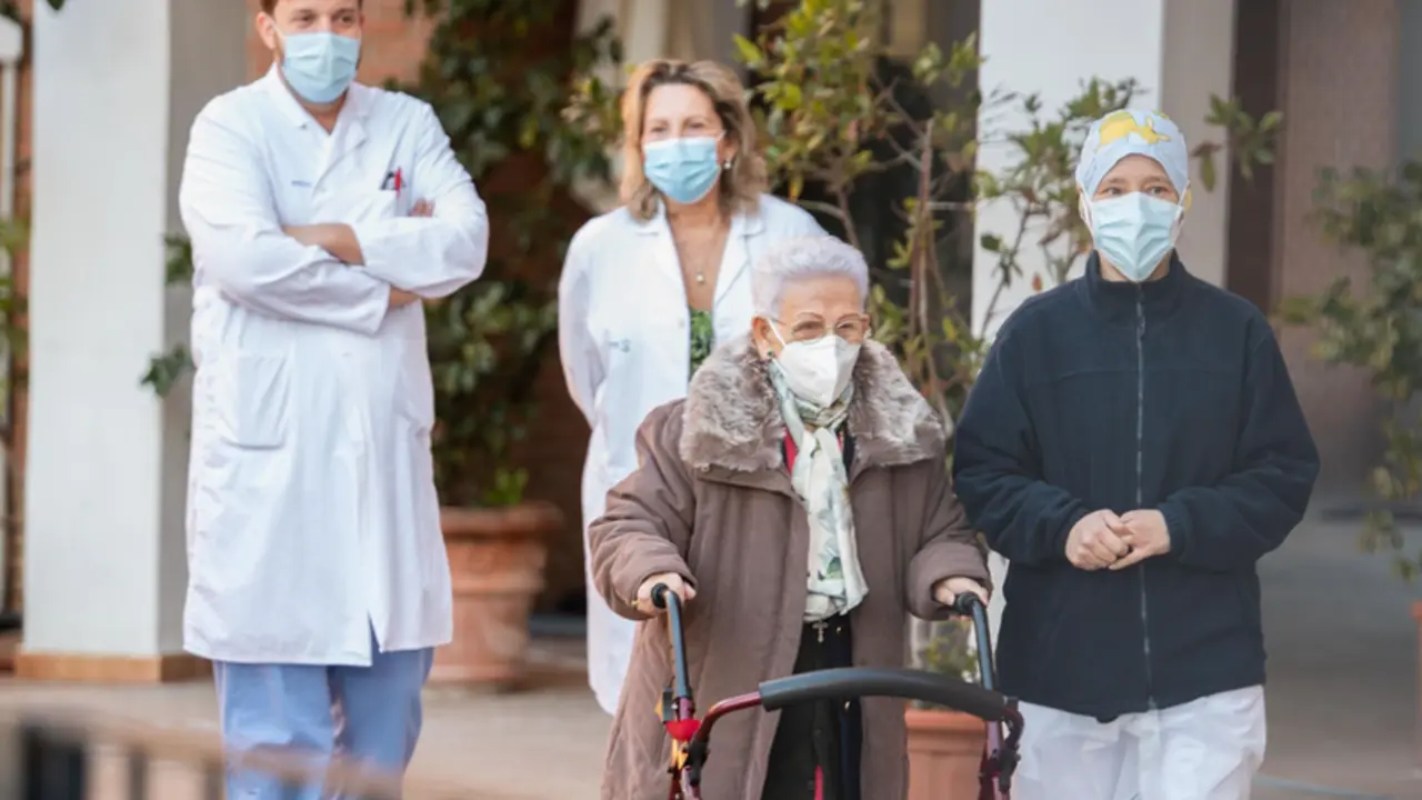  Araceli y M&oacute;nica, la residente m&aacute;s longeva de la Residencia de mayores Los Olmos y la sanitaria m&aacute;s joven, acompa&ntilde;adas de personal del geri&aacute;trico, tras recibir la segunda dosis de la vacuna Pfizer-BioNTech, en Guadalajara, Castilla-La Mancha. - RAFAEL MART&Iacute;N - Europa Press 
