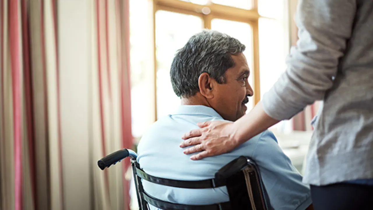 Shot of a young nurse caring for a senior man in a retirement home