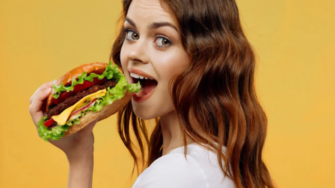 Mujer comiendo una hamburguesa