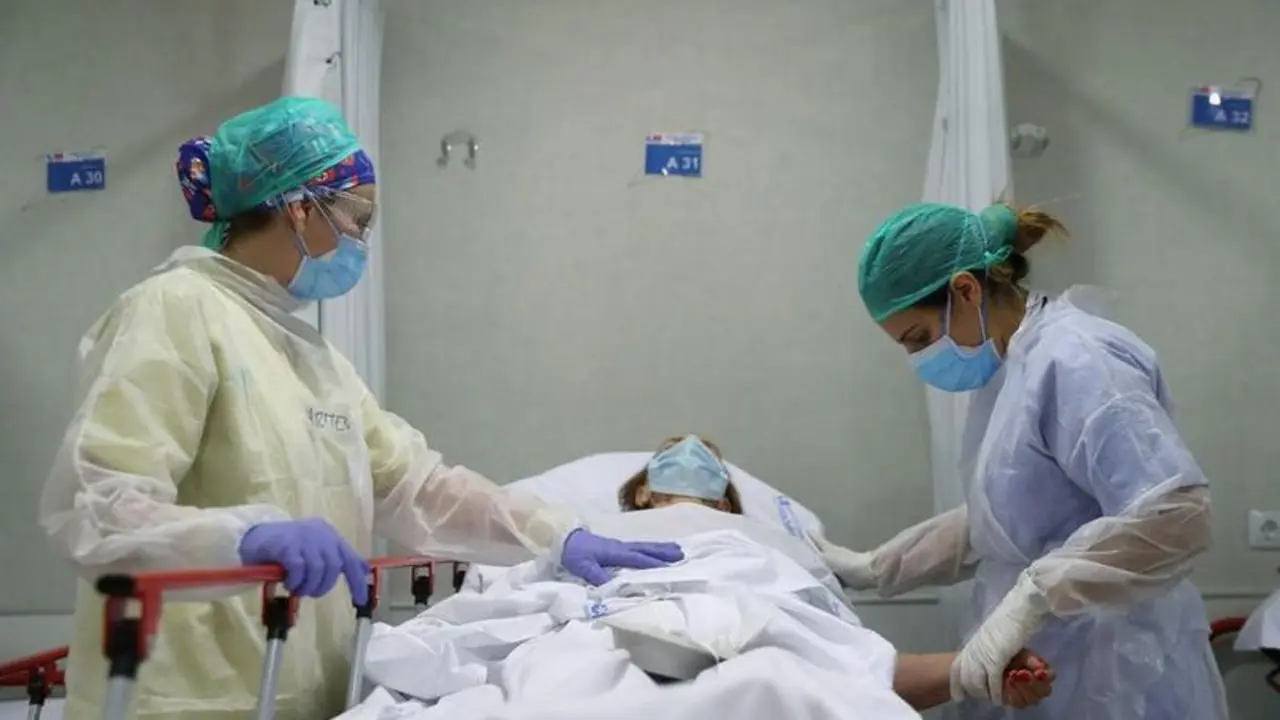 Healthcare workers in protective gear treat an elderly patient at the emergency room as the spread of the coronavirus disease (COVID-19) continues, at Infanta Sofia University hospital in Madrid, Spain, May 8, 2020. REUTERS/Susana Vera