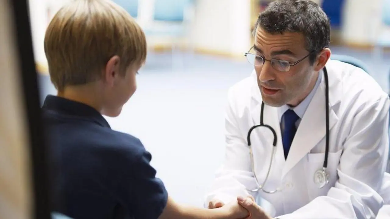Doctor examining young boy