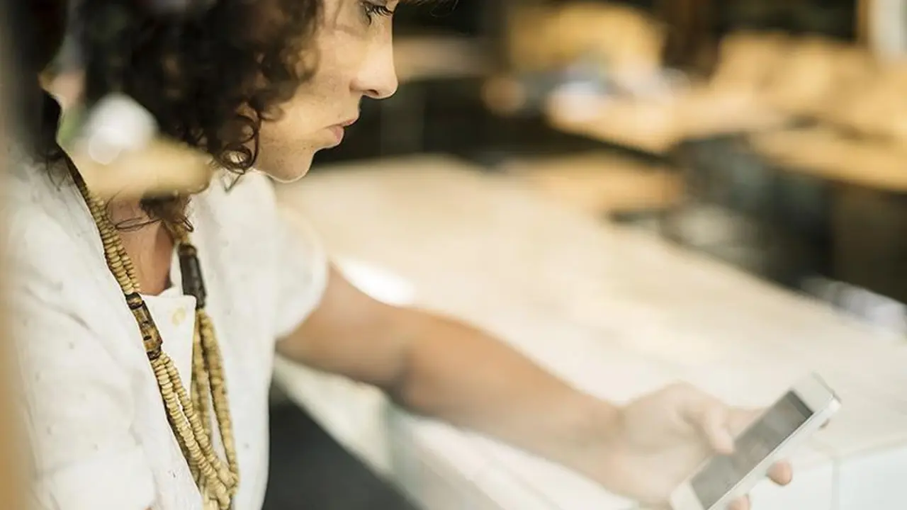  Una mujer realiza una llamada telef&oacute;nica. 