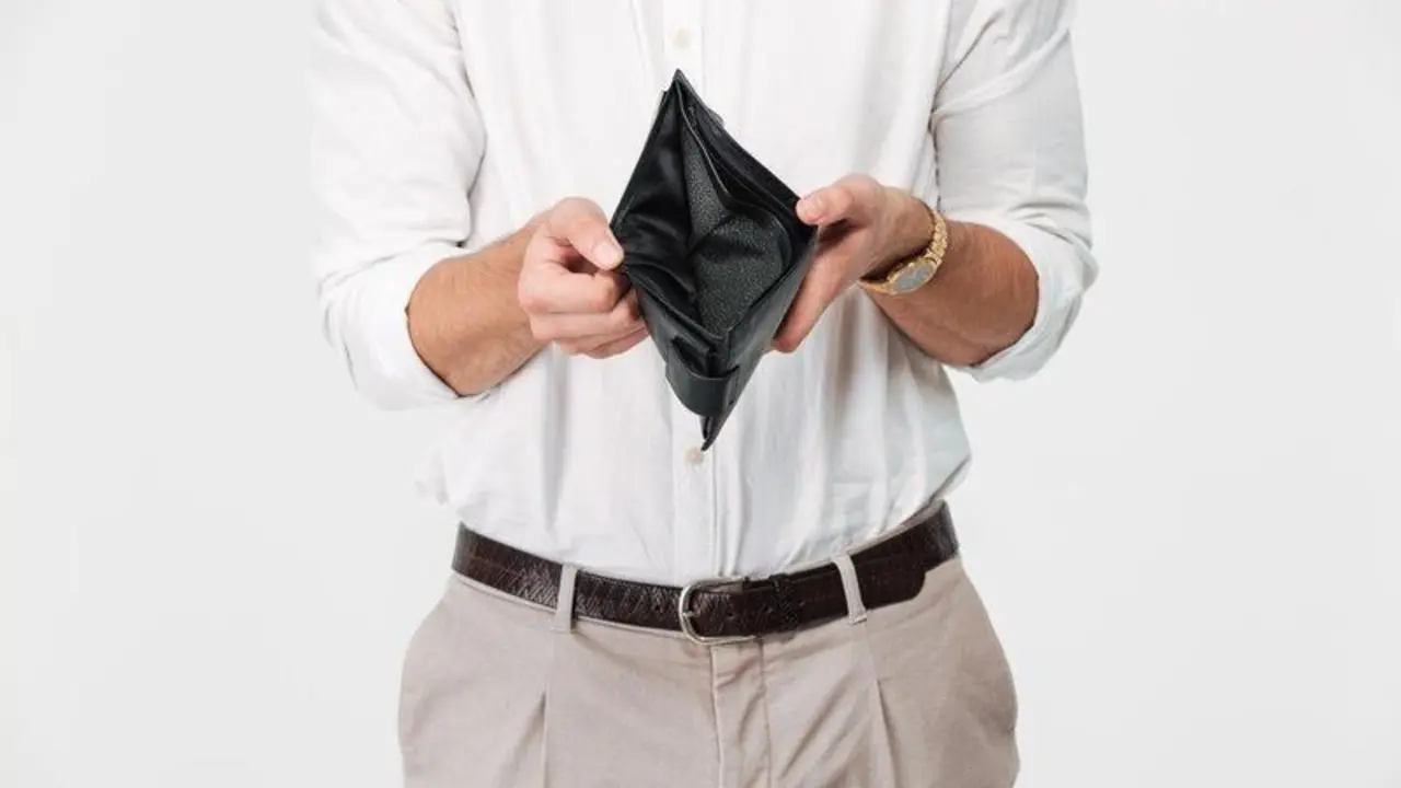 Close up portrait of a man showing empty wallet isolated over white background