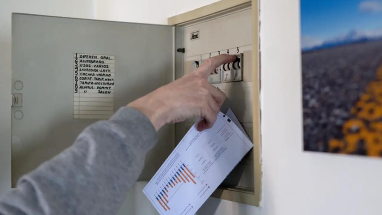 <p> Un hombre sube los plomos de la luz con una factura de luz en la mano, a 3 de enero de 2022, en Madrid - Alberto Ortega - Europa Press </p>