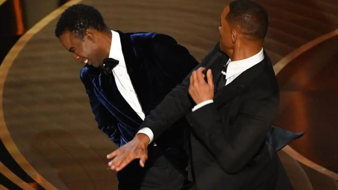 US actor Will Smith (R) slaps US actor Chris Rock speaks onstage during the 94th Oscars at the Dolby Theatre in Hollywood, California on March 27, 2022. (Photo by Robyn Beck / AFP)