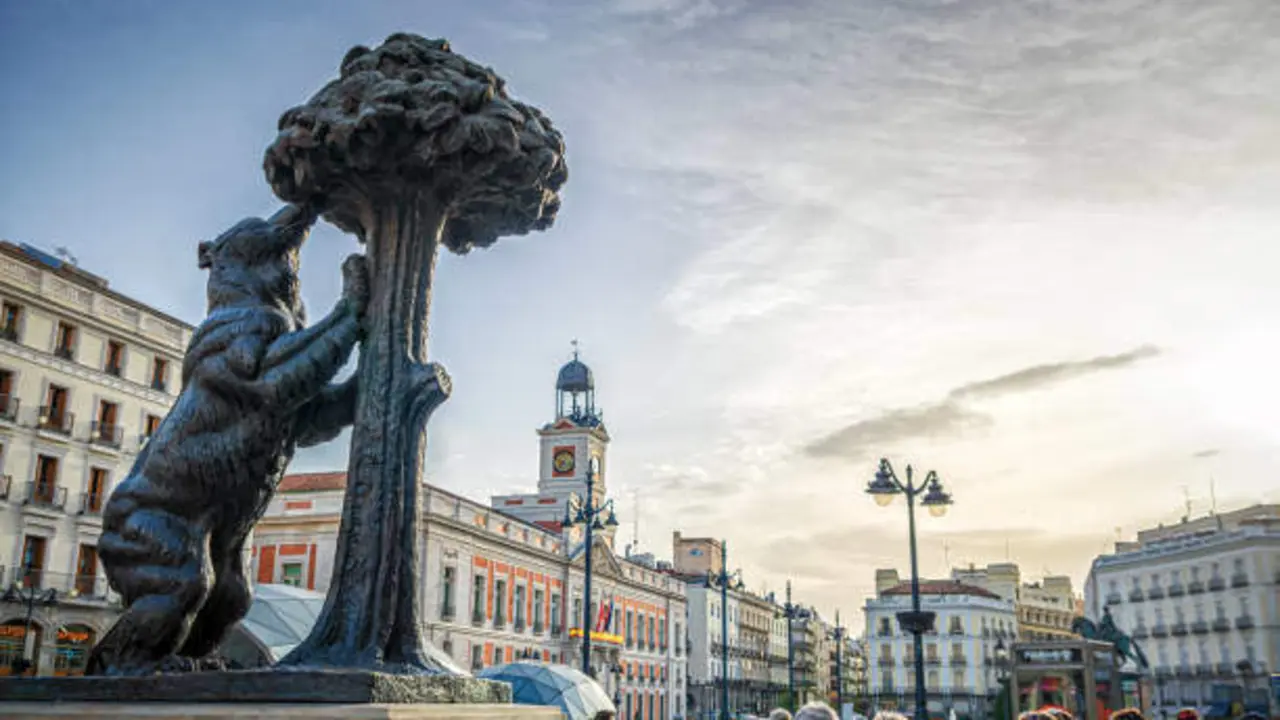 Madrid, Spain - April 24, 2018: tourists in front of the statue of bear and strawberry tree in Madrid, Spain. The bear is a symbol of Madrid and it is situated on Puerta del Sol square and was created by Antonio Navarro Santaf? in 1967