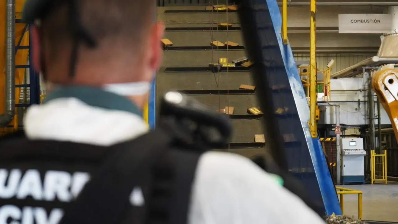  Un agente de la Guardia Civil supervisa droga que se dirige a una m&aacute;quina de combusti&oacute;n para ser destruida. - MINISTERIO DEL INTERIOR 