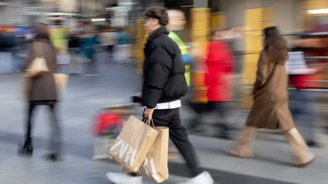 Archivo - Varias personas con bolsas durante las rebajas 