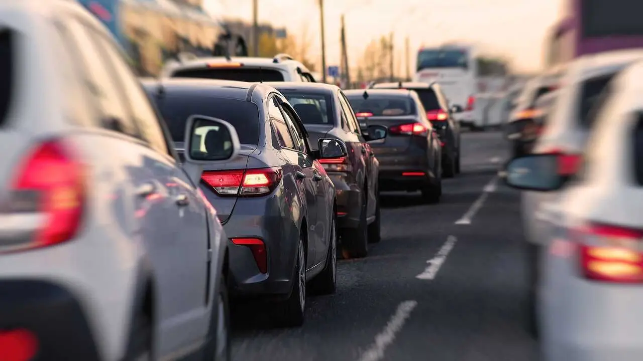 Background, blur, out of focus, bokeh. Traffic jams during rush hours after work. Red brake lights of stopped cars on the background of the city neighborhood.