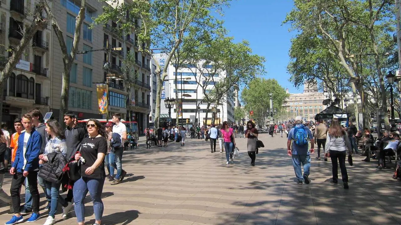 Archivo - Personas paseando por una calle en Barcelona.
