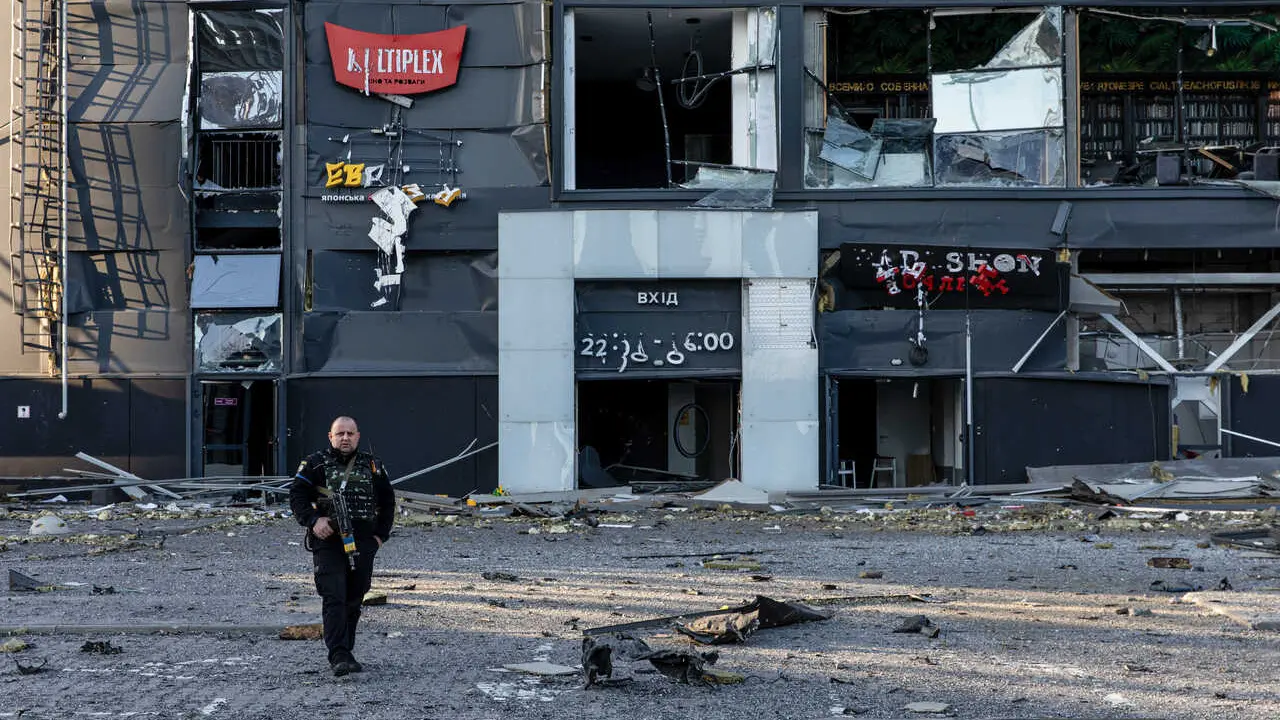 Ukrainian soldier seen patrolling with his rifle at a bomb site during military curfew. Amid Russia's offensive on the capital city of Ukraine, the Retroville mall in Podilskyi district, Kiyv, Ukraine was bombed by a Russian missile on Monday night around 22:30, March 21, 2022, in Kyiv, Ukraine, killing at least 8 people.