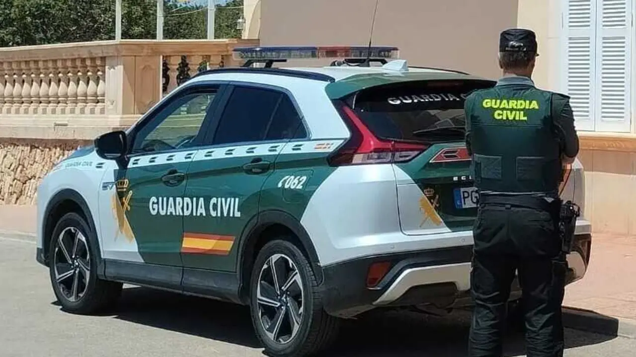 Archivo - Coche y agente de la Guardia Civil.
