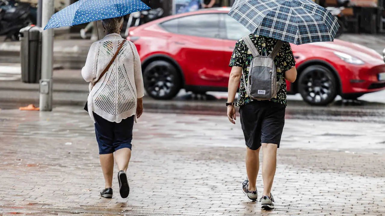 Archivo - Dos personas caminan bajo la lluvia, a 2 de septiembre de 2023, en Madrid (Espa&ntilde;a).