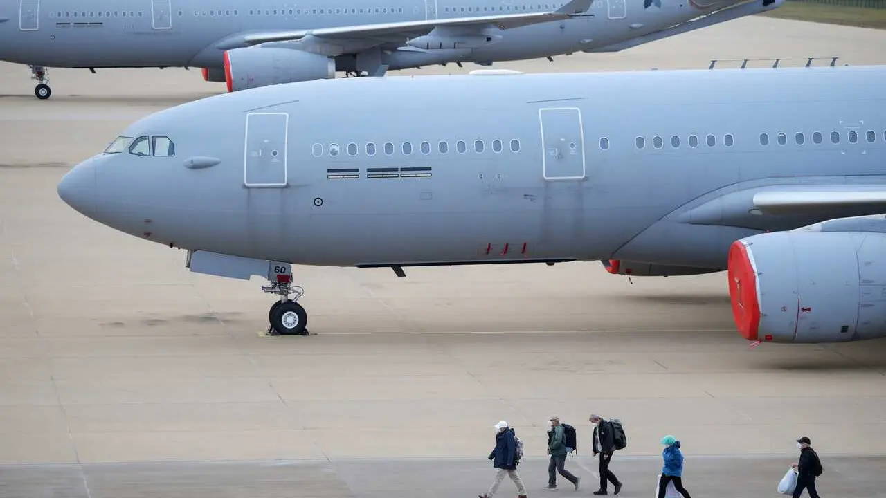 10 May 2026, Netherlands, Eindhoven: Passengers from the cruise ship affected by a hantavirus outbreak disembark from a plane at Eindhoven Airport. 