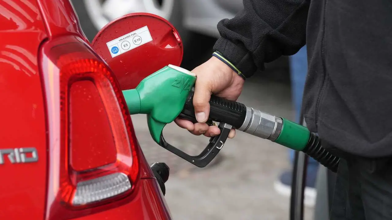 Archivo - Una persona echa combustible