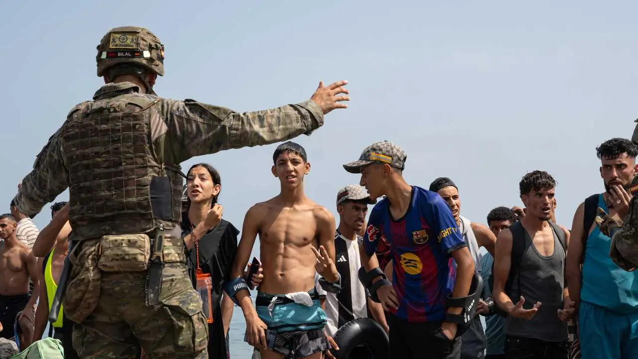 CEUTA, SPAIN &ndash; JULY 31, 2026: Migrants gather near the border crossing between Morocco and the Spanish enclave of Ceuta on July 31, 2026. Tens of thousands of migrants crossed into Ceuta from Morocco, while some continued to arrive and others voluntarily returned due to the precarious situation. Photo by Mario Moron / JNA Press.