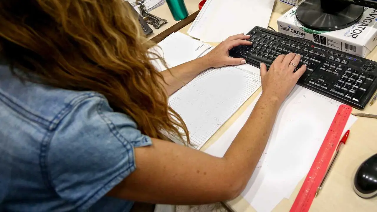 Archivo - Una mujer escribe en el teclado de su ordenador