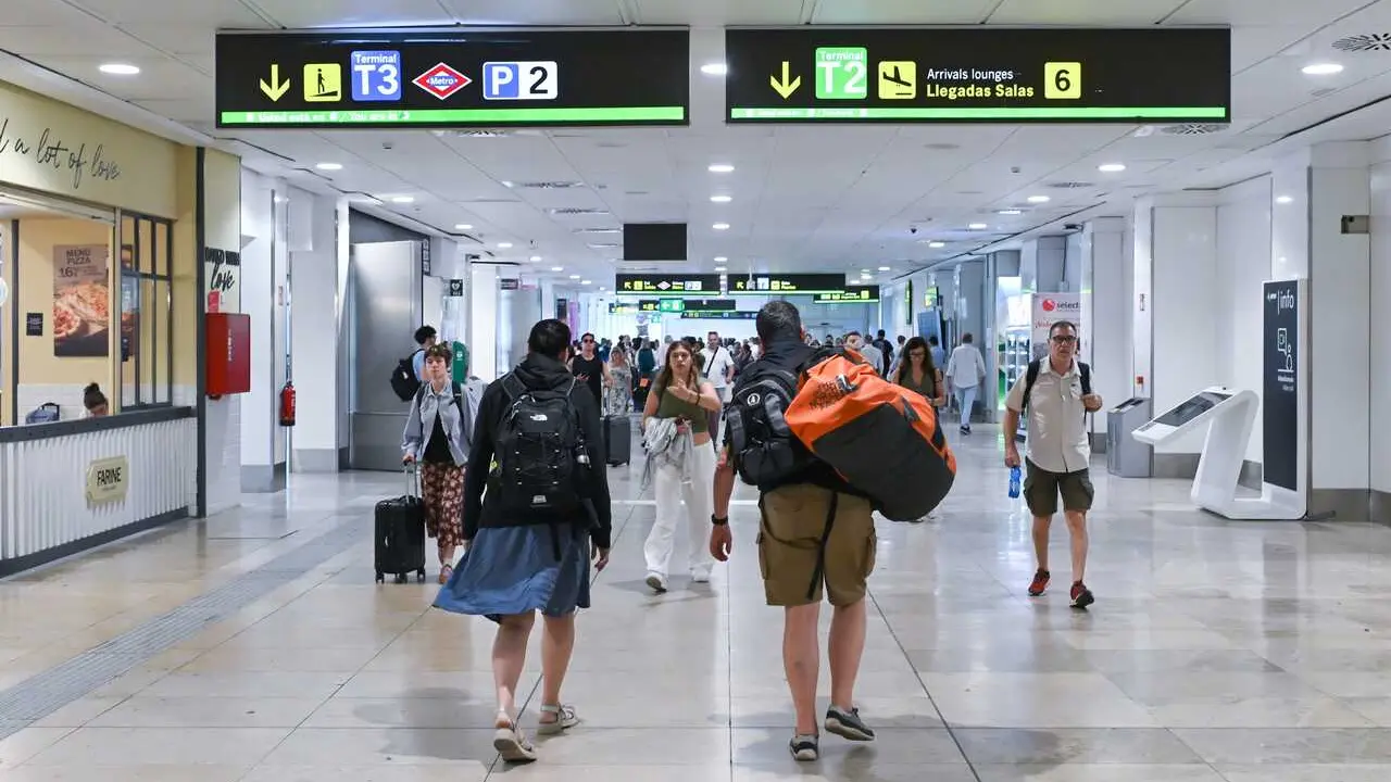 Varias personas en la zona de llegadas de la T2 del aeropuerto de Madrid.