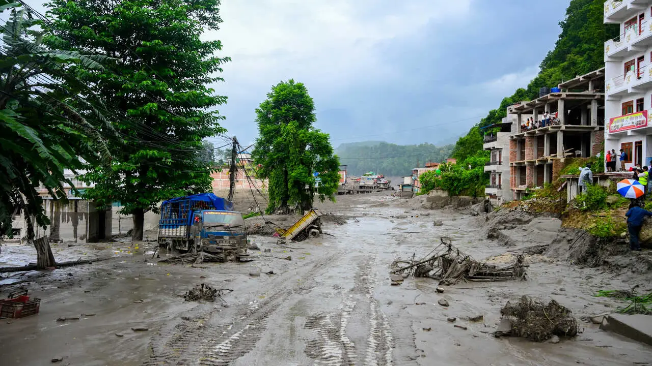 NUWAKOT, NEPAL - AUGUST 26: An aftermath view of flash floods and mudslides along the Trishuli River in Nuwakot, Nepal, on August 26, 2026. A catastrophic flash flood swept through Nepal&rsquo;s northern border region after an ice-and-rock avalanche, reportedly triggered by an earthquake, caused a sudden surge in the Lhende River on the Nepal-China border and sent massive volumes of water, mud and debris downstream into the Bhote Koshi and Trishuli river systems. The disaster devastated settlements in Rasuwa and Nuwakot districts, sweeping away homes, roads, bridges, vehicles and other infrastructure and severely damaging hydropower and power facilities. In Nuwakot, riverside settlements including Trishuli Bazaar, Devighat, Betrawati and surrounding areas suffered extensive destruction, with homes swept away and large quantities of mud and debris deposited across communities. The flood also disrupted communications and transportation routes and prompted authorities to evacuate vulnerable riverside communities and issue warnings along the Bhote Koshi, Trishuli and Narayani rivers. The death toll from the disaster had climbed to 97, while at least 384 tourists and travelers, including foreign nationals, as well as soldiers and police personnel, were reported missing as search-and-rescue operations continued. Nepal Army, Armed Police Force and Nepal Police personnel were deployed to affected areas, while rescue operations were also underway on the Chinese side of the border. Authorities continued to assess the scale of casualties and destruction as access to several affected areas remained difficult because of damaged roads, bridges, heavy sediment and continuing flood risks. The disaster has been described as one of the most severe sudden flood events to strike the Nepal-China border region in recent years.