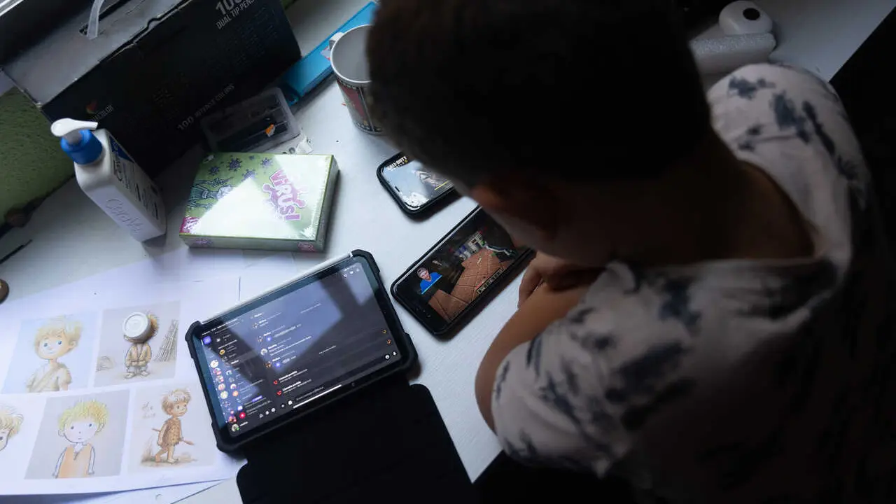Archivo - Un ni&ntilde;o usa el tel&eacute;fono m&oacute;vil y una tablet, a 18 de octubre de 2023, en Madrid (Espa&ntilde;a). Seg&uacute;n la Vanguardia, en Espa&ntilde;a se estima que el 21% de los adolescentes es adicto a la red y casi la mitad reconoce que tiene 'un contacto activo' cada 15 m