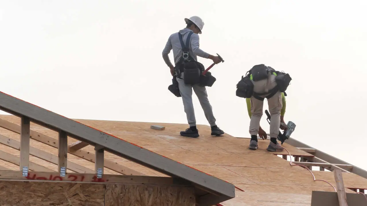 Two construction workers install roof sheathing on a two-story home under construction in the Phoenix metropolitan area. Arizona added the most construction jobs in the U.S. over the past year, gaining 3,900 positions, or 1.7%, according to an analysis of new federal data by the Associated General Contractors of America, which reported construction employment rose in 34 states and the District of Columbia.